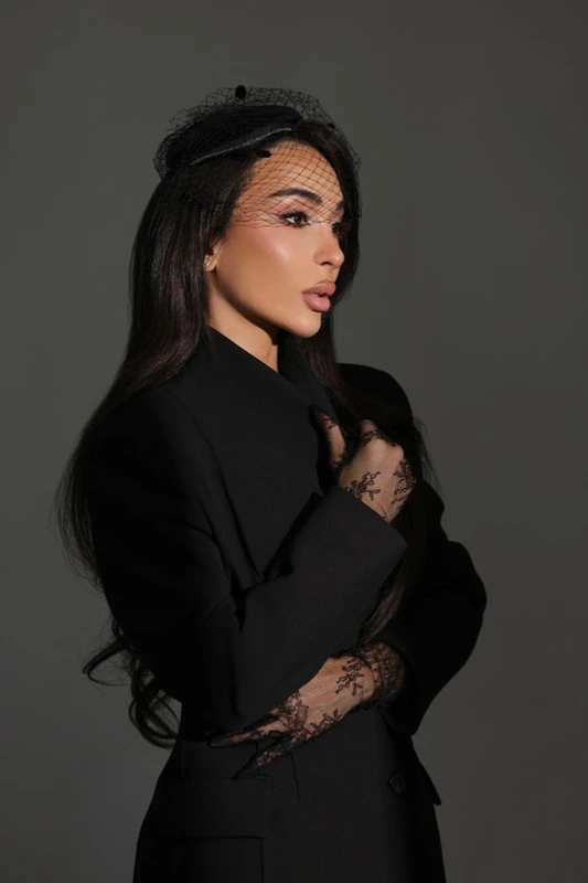 Lailli Mirza in a black tailored outfit